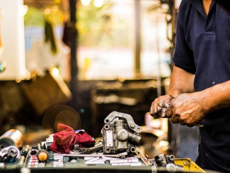mechanic working on car parts in a garage