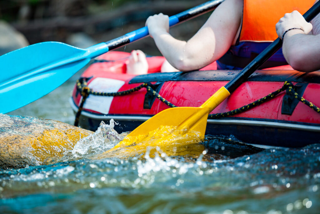 Close-up hand of a person rafting on the river, extreme and fun sport at tourist attraction