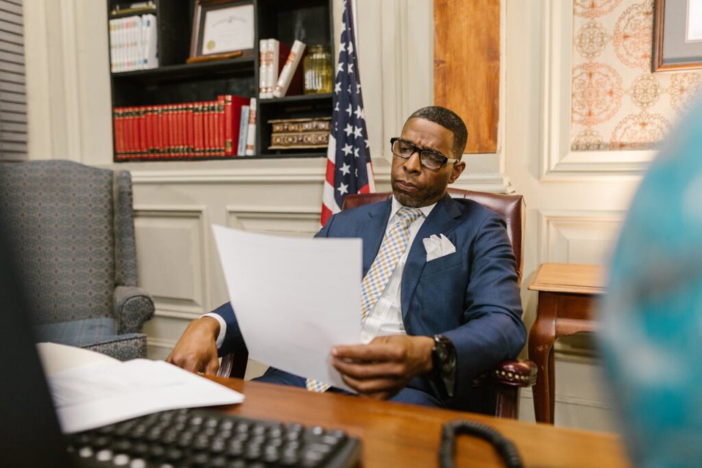 Photo by RDNE Stock project: https://www.pexels.com/photo/an-attorney-in-blue-suit-holding-a-document-while-sitting-7841443/