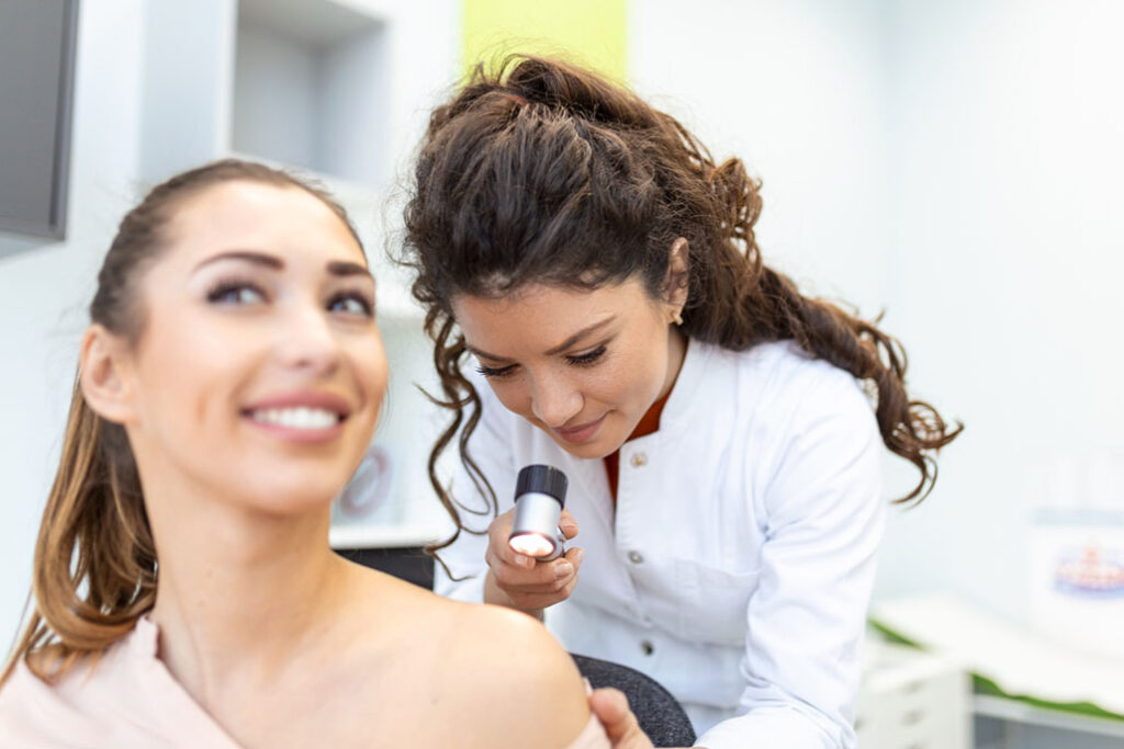 dermatologist examining a patient
