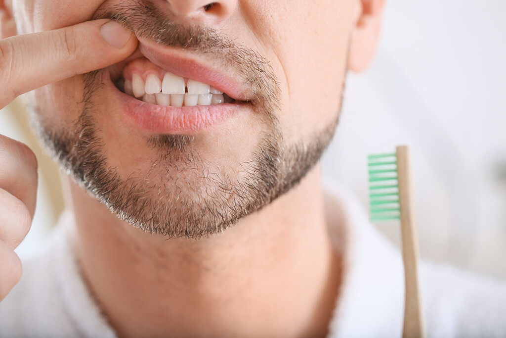Man suffering from tooth ache in morning, closeup