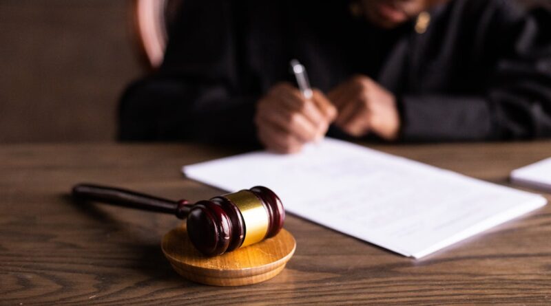 Photo by KATRIN BOLOVTSOVA: https://www.pexels.com/photo/judge-signing-on-the-papers-6077447/
